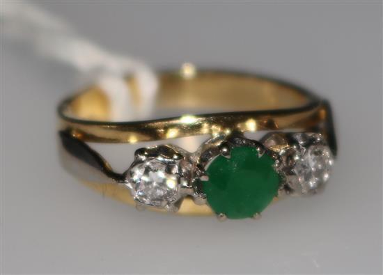 A gold and three stone emerald and diamond ring, size G.